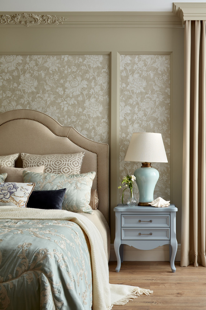 This is an example of a large traditional master and grey and white bedroom in Other with green walls, laminate floors, brown floors and wallpapered walls.