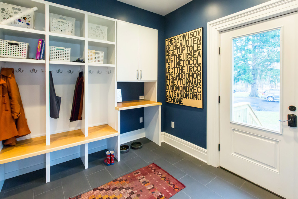 Traditional mudroom in Boston with blue walls and grey floor.