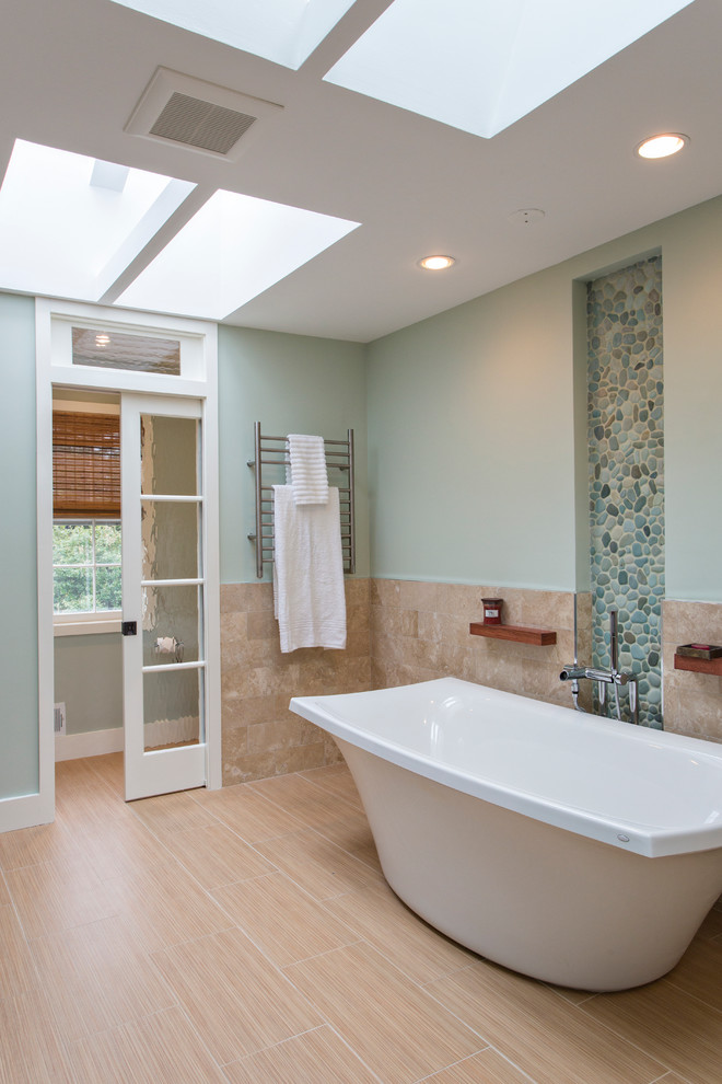Photo of a large beach style master bathroom in DC Metro with beige tile, ceramic tile, a freestanding tub and blue walls.