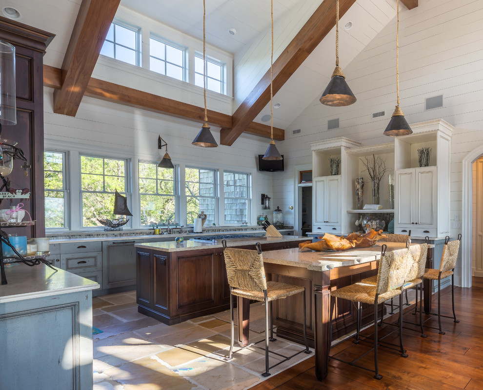 Design ideas for a large beach style u-shaped open plan kitchen in Charleston with recessed-panel cabinets, distressed cabinets, granite benchtops, stainless steel appliances, ceramic floors and multiple islands.