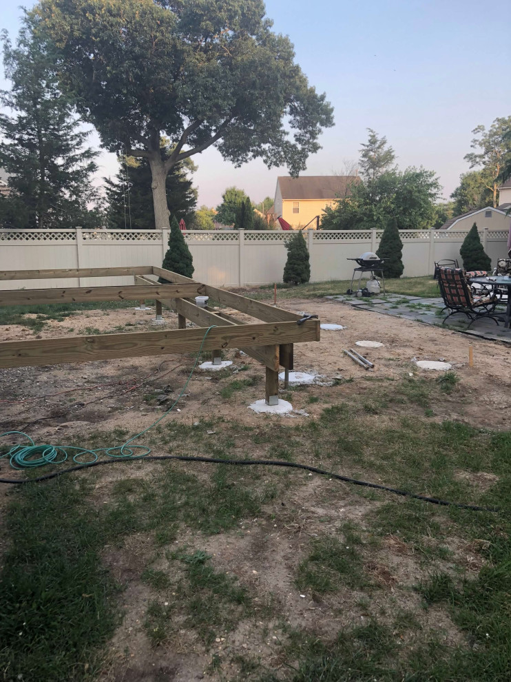 Inspiration for a large timeless backyard deck remodel