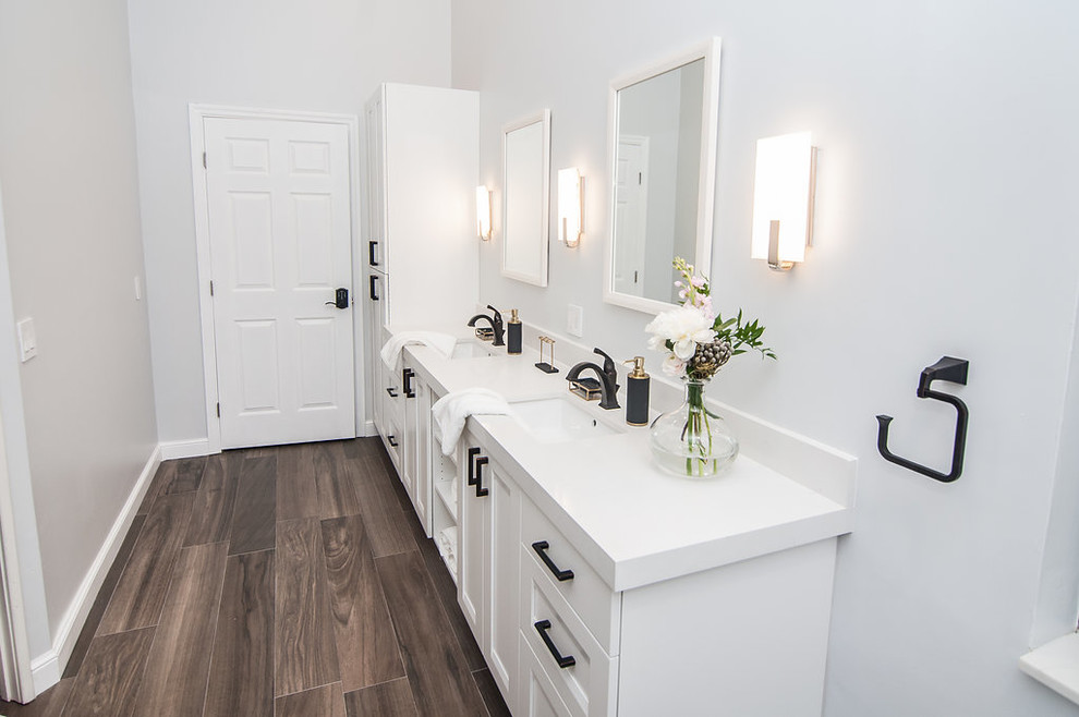 This is an example of a mid-sized transitional master bathroom in Miami with shaker cabinets, white cabinets, a freestanding tub, a corner shower, a one-piece toilet, yellow tile, stone slab, grey walls, porcelain floors, an undermount sink, engineered quartz benchtops, brown floor, a sliding shower screen and yellow benchtops.