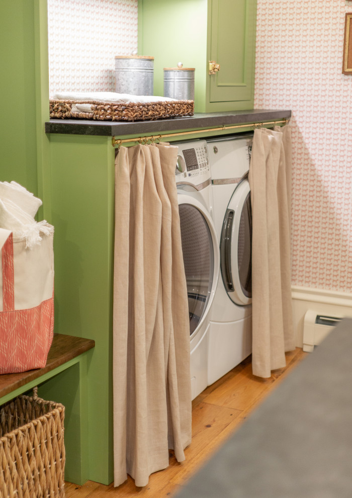 This is an example of a transitional laundry room in Boston with an integrated sink, recessed-panel cabinets, green cabinets, soapstone benchtops and black benchtop.