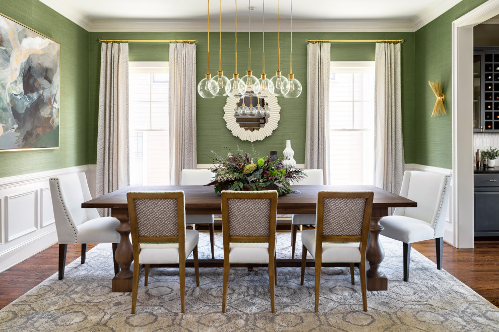 Photo of a transitional dining room in Atlanta with green walls and medium hardwood floors.