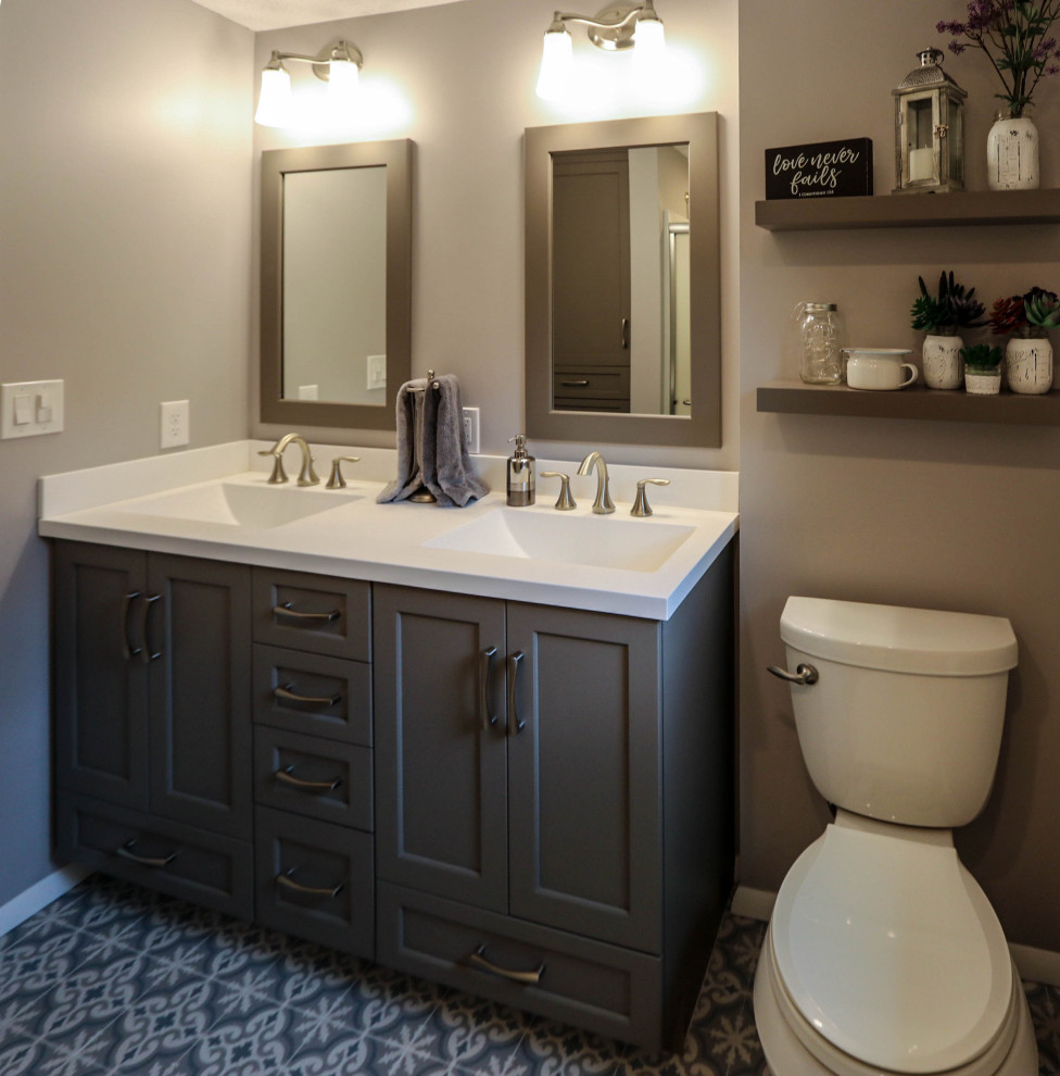 Inspiration for a small transitional master bathroom with flat-panel cabinets, grey cabinets, an alcove shower, a two-piece toilet, gray tile, grey walls, ceramic floors, an integrated sink, marble benchtops, blue floor, a sliding shower screen, white benchtops, a double vanity and a built-in vanity.
