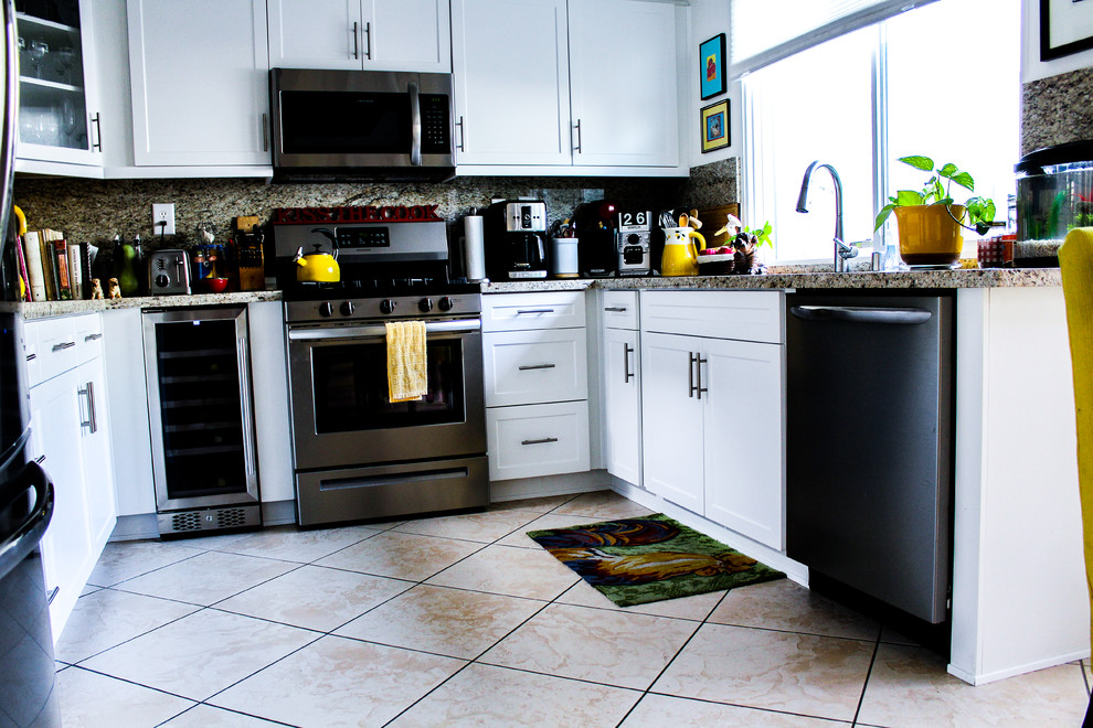 Inspiration for a mid-sized transitional u-shaped porcelain tile and beige floor enclosed kitchen remodel with an undermount sink, shaker cabinets, white cabinets, granite countertops, brown backsplash, stone slab backsplash, stainless steel appliances, no island and brown countertops