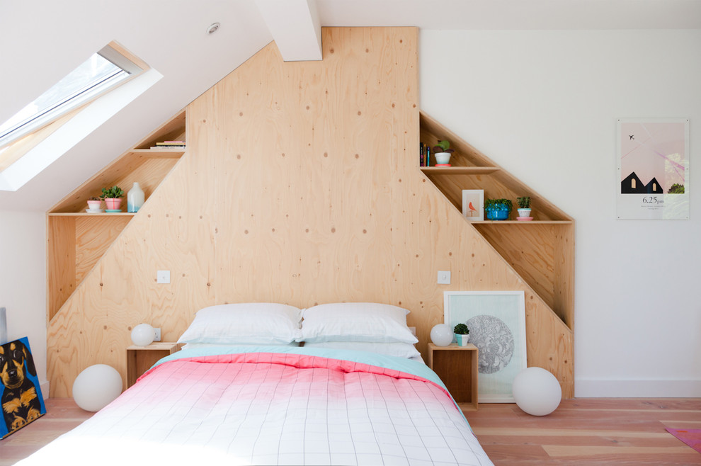 This is an example of a mid-sized contemporary bedroom in London with white walls and light hardwood floors.