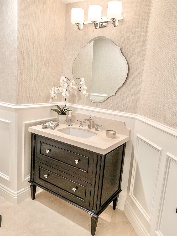 Inspiration for a small classic cloakroom in Orange County with recessed-panel cabinets, brown cabinets, beige walls, marble flooring, a submerged sink, limestone worktops, beige floors, beige worktops, a freestanding vanity unit and wallpapered walls.