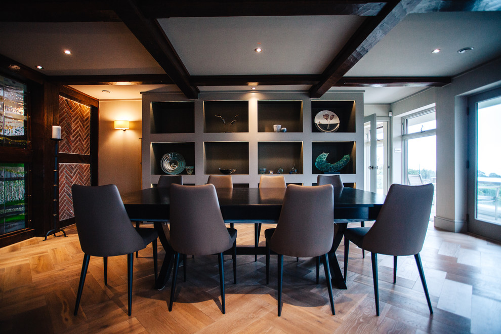 Photo of a large contemporary separate dining room in Cornwall with grey walls and medium hardwood floors.