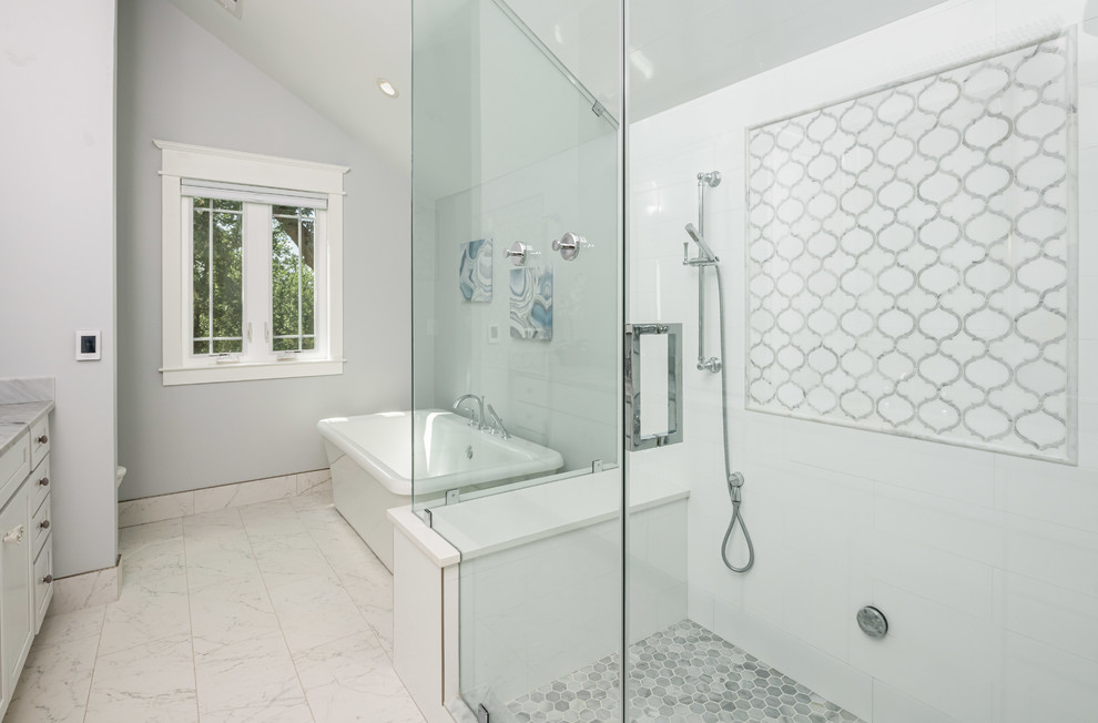 Design ideas for a large transitional master bathroom in DC Metro with shaker cabinets, white cabinets, a freestanding tub, a corner shower, a two-piece toilet, white tile, grey walls, an undermount sink, white floor, a hinged shower door, white benchtops, porcelain tile, porcelain floors and marble benchtops.