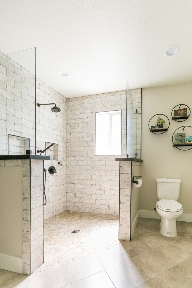 Country bathroom in Santa Barbara with a curbless shower and a wall-mount sink.