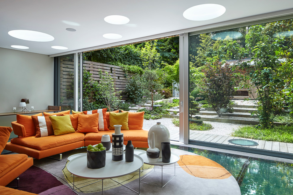 This is an example of a large modern sunroom in London.