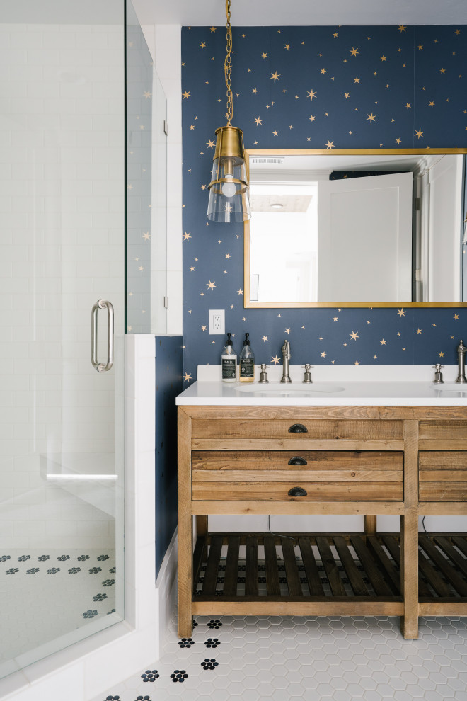 This is an example of a transitional kids bathroom in Salt Lake City with flat-panel cabinets, medium wood cabinets, a corner shower, white tile, subway tile, multi-coloured walls, an undermount sink, white floor, a hinged shower door and white benchtops.