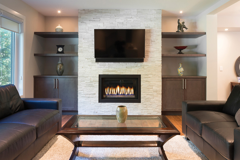 This is an example of a mid-sized modern formal open concept living room in Other with medium hardwood floors, a ribbon fireplace, a stone fireplace surround, a wall-mounted tv and grey walls.