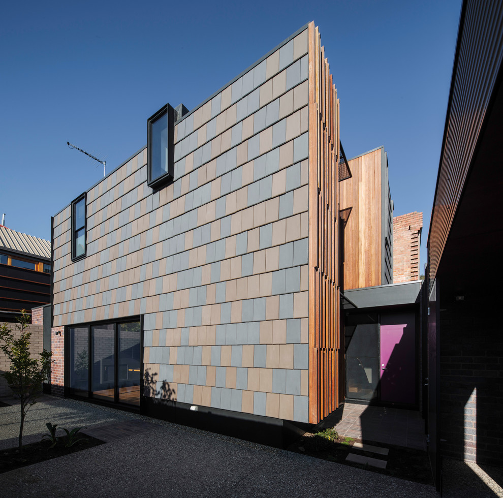 This is an example of a mid-sized modern two-storey brown exterior in Melbourne with wood siding and a flat roof.