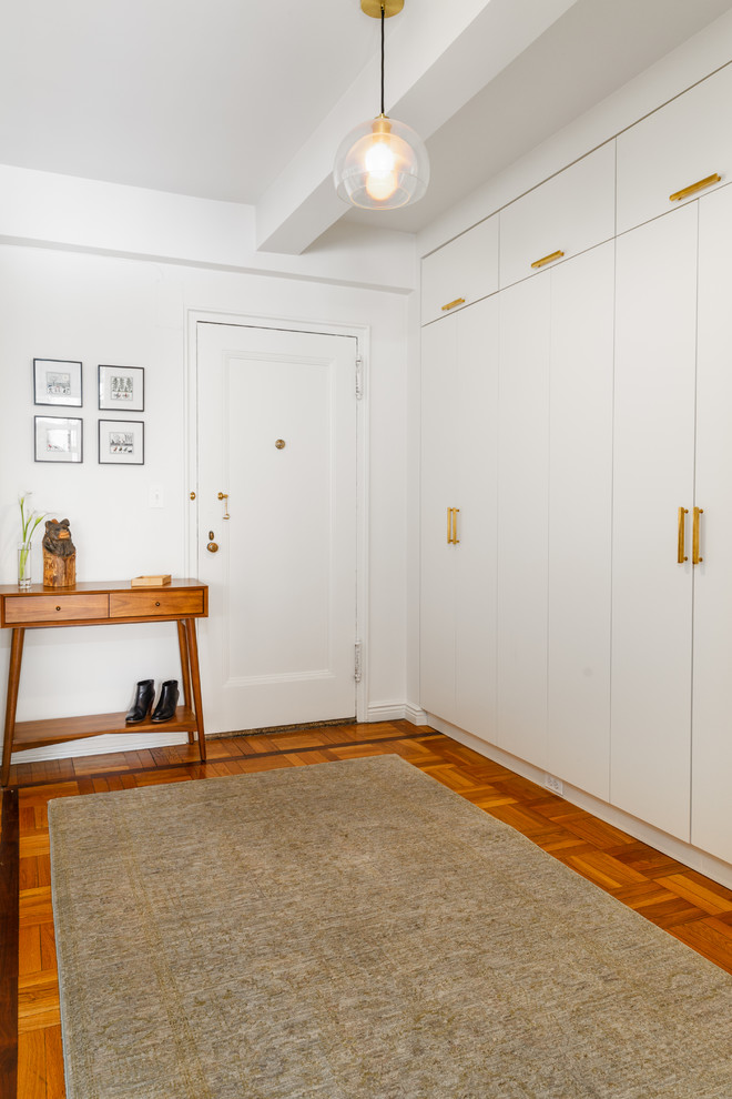 Design ideas for a mid-sized transitional foyer in New York with white walls, a single front door and a yellow front door.