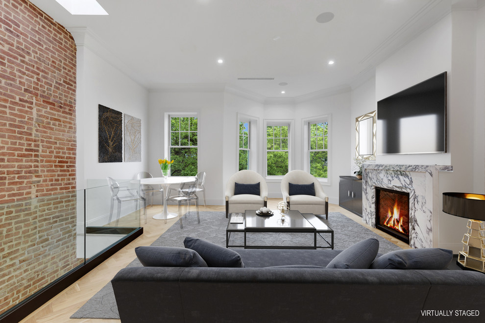 This is an example of a mid-sized modern formal open concept living room in New York with white walls, medium hardwood floors, a standard fireplace, a stone fireplace surround, a wall-mounted tv and black floor.