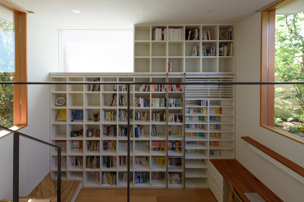Photo of a modern family room in Tokyo Suburbs with a library, white walls and medium hardwood floors.
