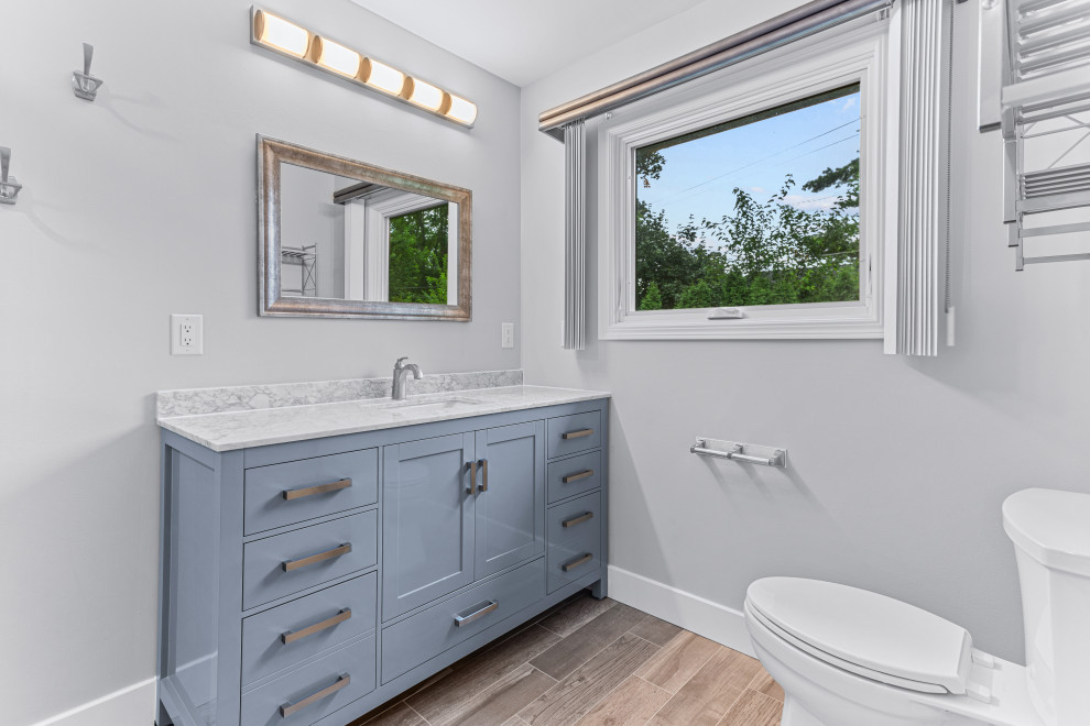 Contemporary master bathroom in Detroit with shaker cabinets, grey cabinets, an open shower, a two-piece toilet, grey walls, an undermount sink, engineered quartz benchtops, brown floor, a sliding shower screen, a single vanity and a built-in vanity.