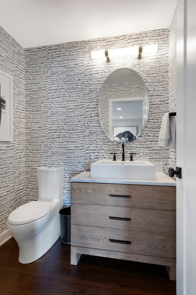 Inspiration for a small midcentury powder room in Minneapolis with flat-panel cabinets, light wood cabinets, a two-piece toilet, white walls, dark hardwood floors, a vessel sink, quartzite benchtops, brown floor, white benchtops, a freestanding vanity and wallpaper.