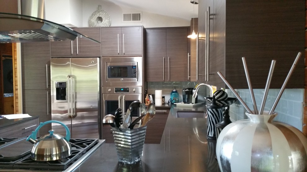 Eat-in kitchen - mid-sized transitional l-shaped eat-in kitchen idea in Austin with an undermount sink, flat-panel cabinets, brown cabinets, concrete countertops, blue backsplash, glass tile backsplash, stainless steel appliances and a peninsula