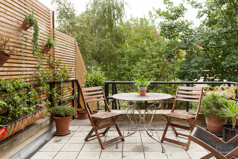 Inspiration for a contemporary rooftop and first floor deck in London with a container garden and no cover.