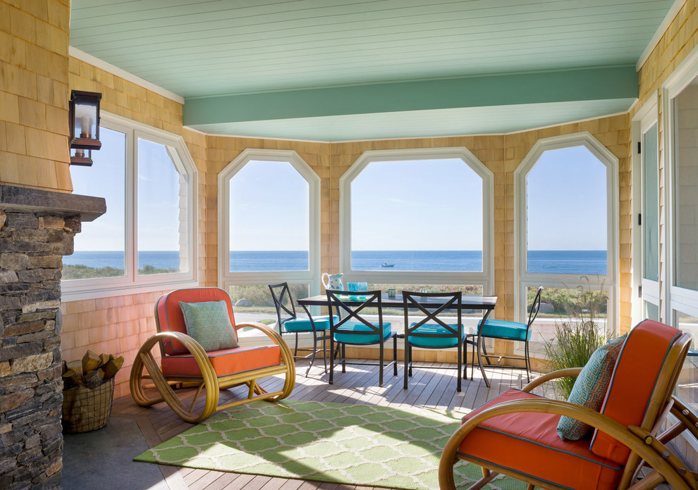 This is an example of a beach style screened-in verandah in Bridgeport with decking and a roof extension.