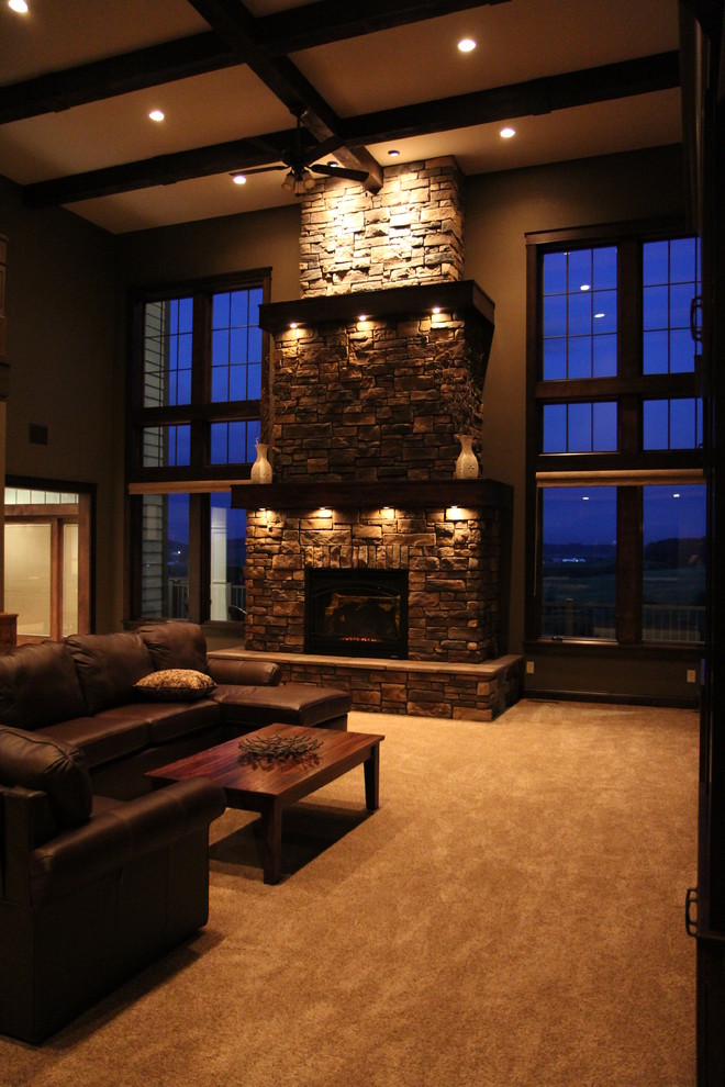 Inspiration for a large arts and crafts open concept living room in Minneapolis with brown walls, carpet, a standard fireplace and a stone fireplace surround.