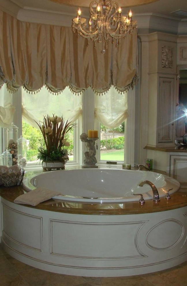 Inspiration for a beige tile porcelain tile bathroom remodel with white cabinets, granite countertops and a hot tub