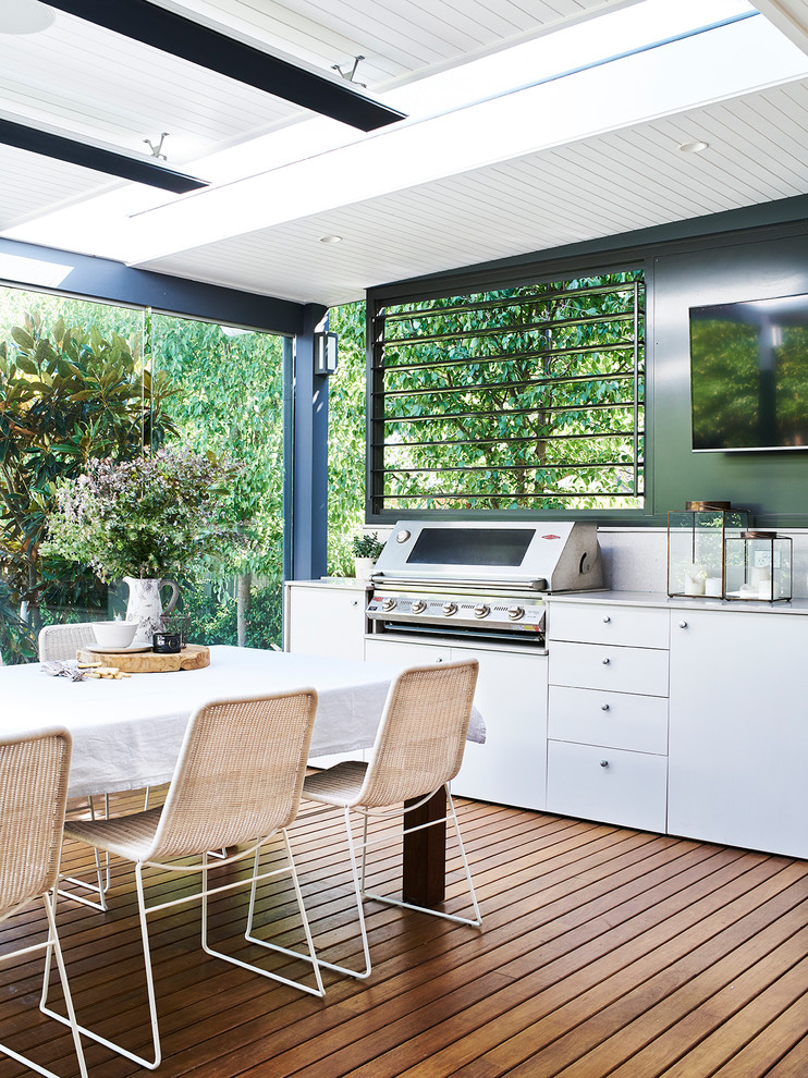Design ideas for a large transitional backyard deck in Sydney with an outdoor kitchen and a roof extension.