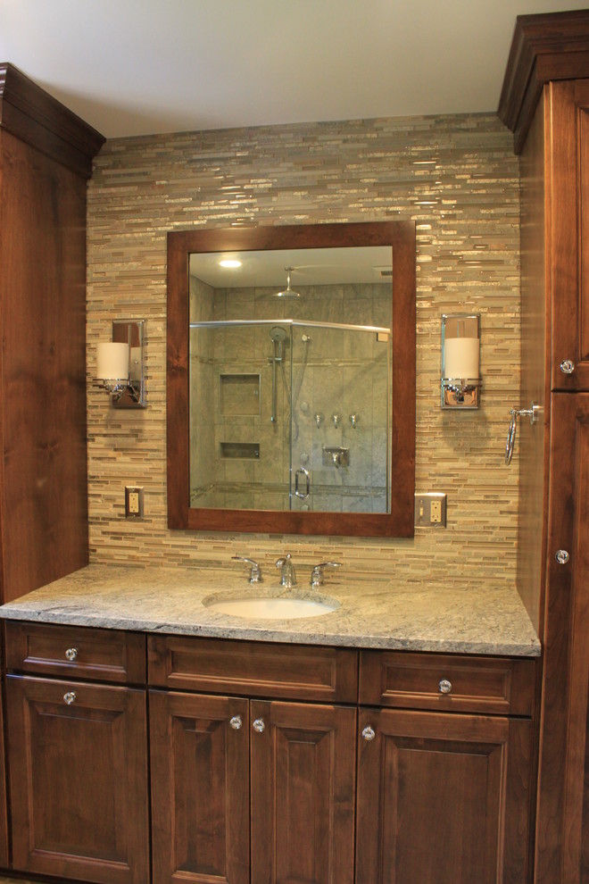 This is an example of a large transitional master bathroom in Other with raised-panel cabinets, dark wood cabinets, granite benchtops, multi-coloured tile, an alcove shower, a two-piece toilet, matchstick tile, beige walls, linoleum floors and an undermount sink.