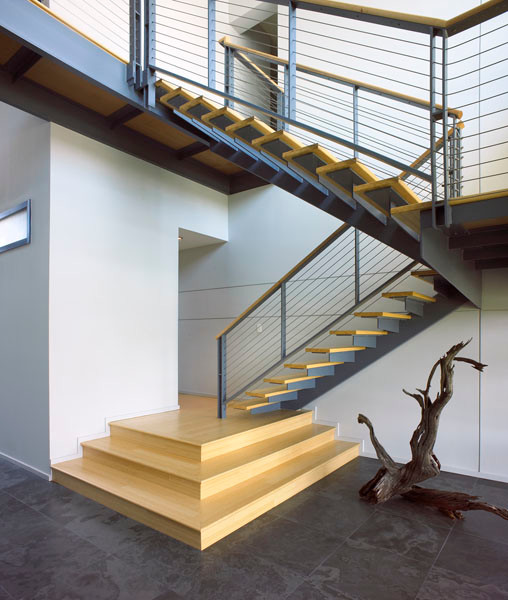 Photo of a mid-sized industrial wood l-shaped staircase in Tampa with metal risers.