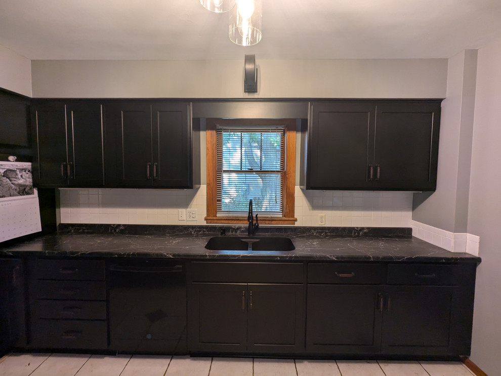 Inspiration for a mid-sized transitional eat-in kitchen remodel with shaker cabinets, black cabinets, laminate countertops and black countertops