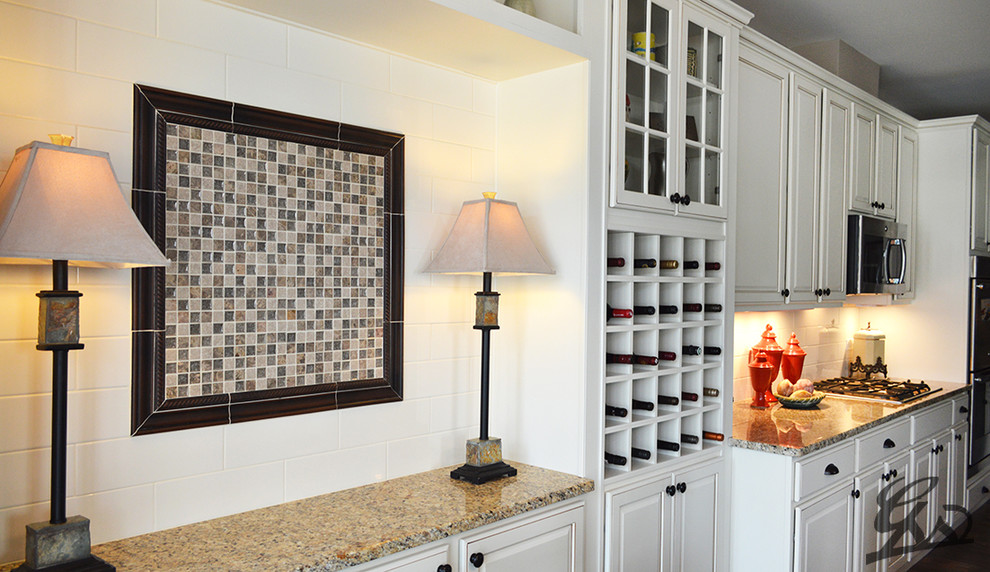 Example of a classic medium tone wood floor and brown floor kitchen design in Chicago with granite countertops, white backsplash and ceramic backsplash