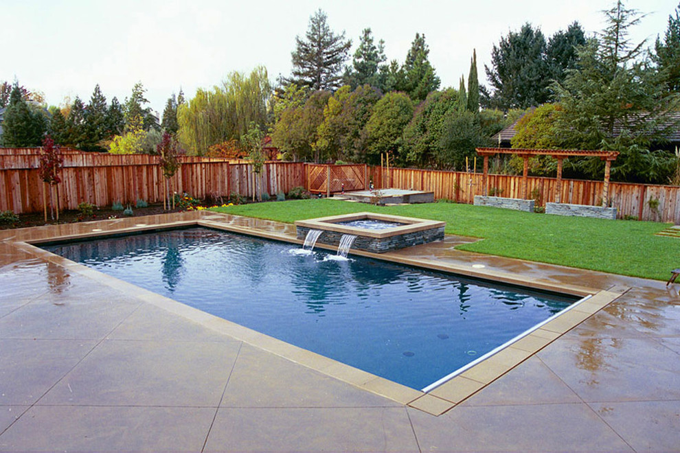 Design ideas for a large contemporary backyard rectangular lap pool in San Francisco with a hot tub and concrete slab.