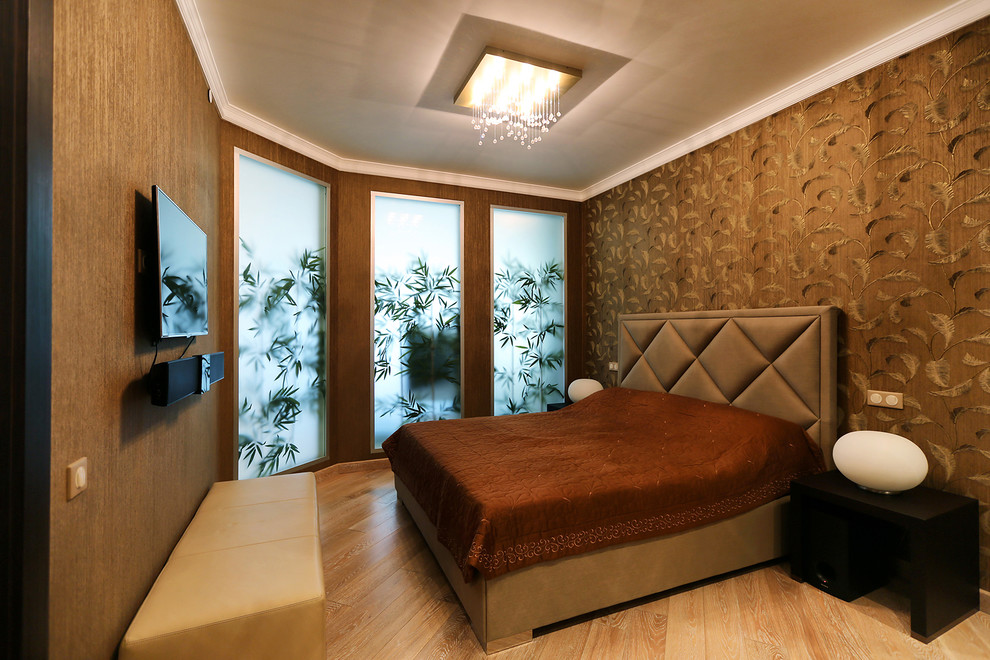 Inspiration for a contemporary bedroom in Moscow with brown walls and light hardwood floors.
