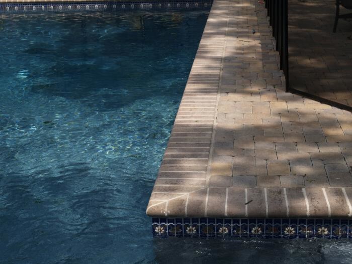 Inspiration for a mid-sized mediterranean backyard round natural pool in New York with natural stone pavers.