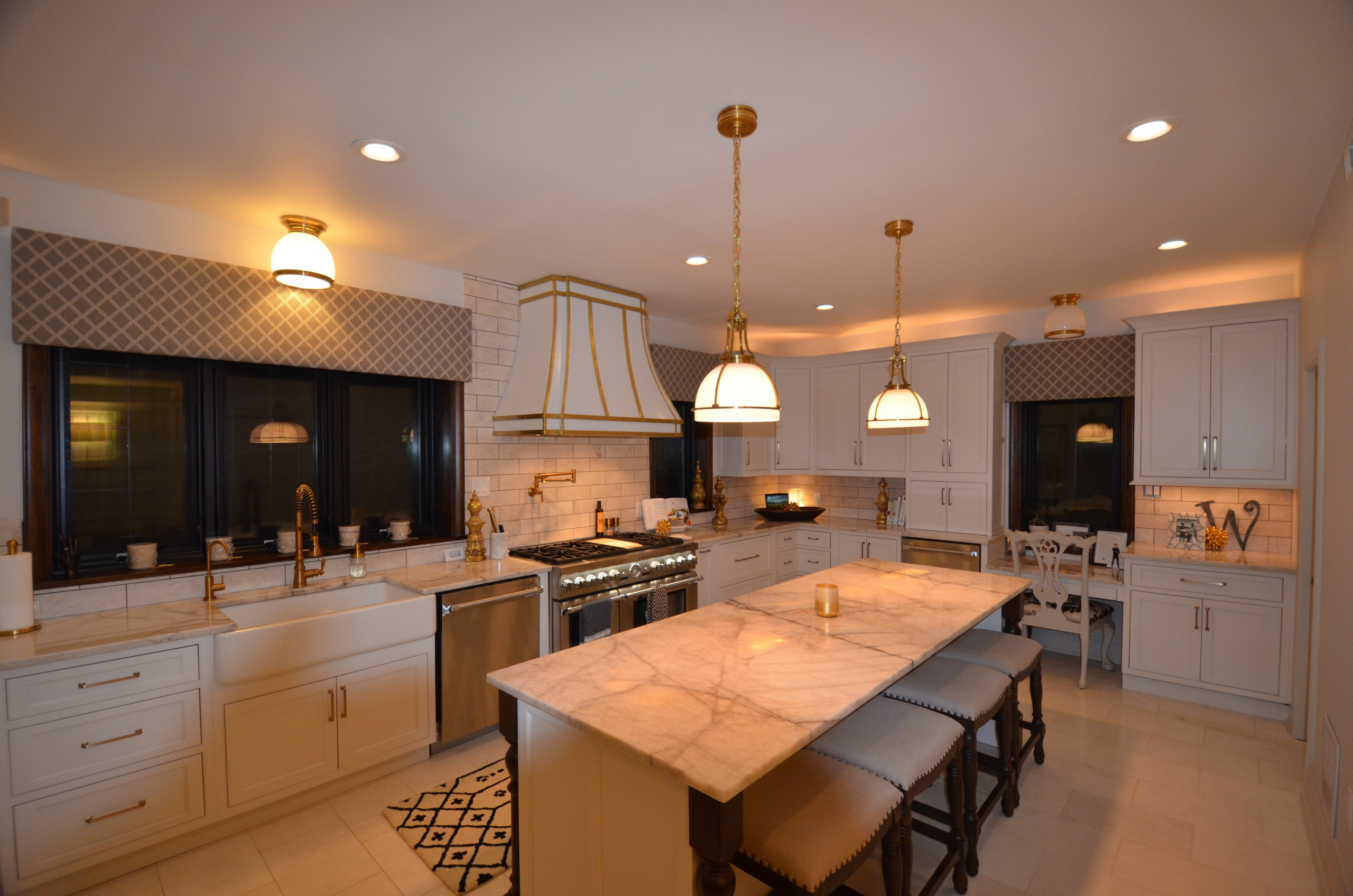Example of a classic kitchen design in St Louis with beaded inset cabinets, white cabinets, quartzite countertops, marble backsplash and stainless steel appliances