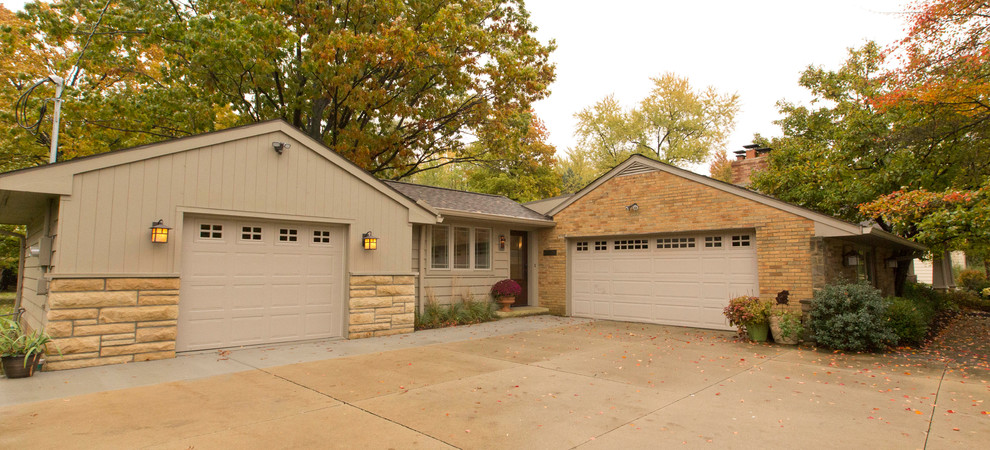 Example of a transitional attached one-car garage design in Cleveland