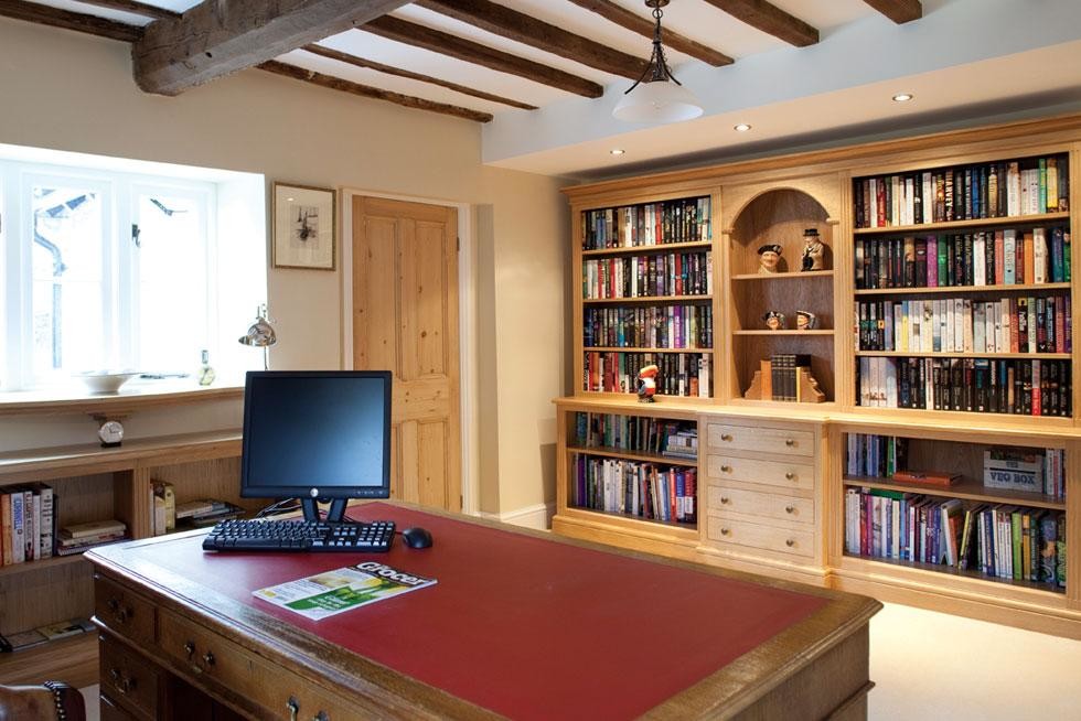 Photo of a mid-sized traditional study room in Other with beige walls, carpet, a freestanding desk and beige floor.