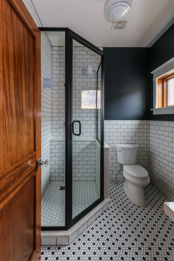 This is an example of a small country 3/4 bathroom in Seattle with a corner shower, a two-piece toilet, white tile, subway tile, black walls, porcelain floors, a vessel sink, engineered quartz benchtops, black floor, a hinged shower door and white benchtops.