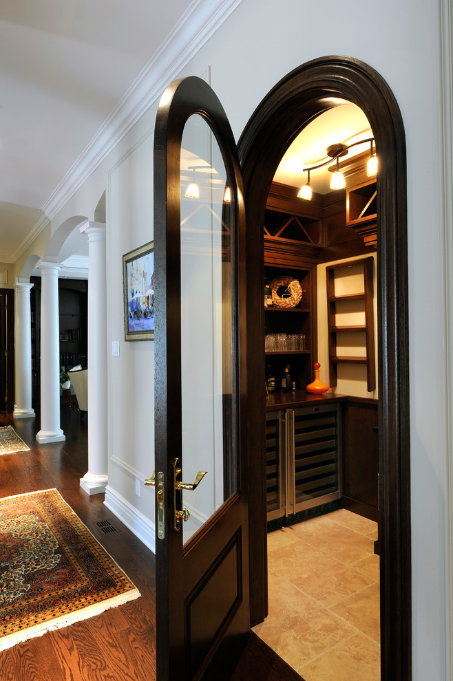 Design ideas for a mid-sized transitional wine cellar in Ottawa with ceramic floors.