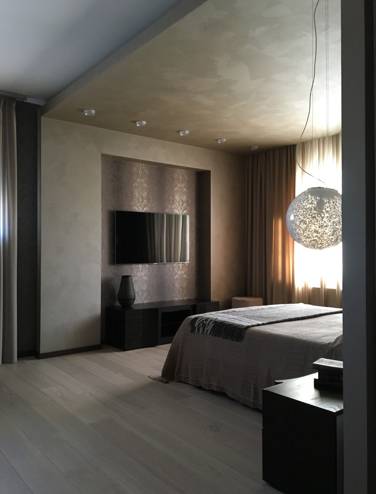 Photo of a large contemporary master bedroom in Moscow with light hardwood floors.