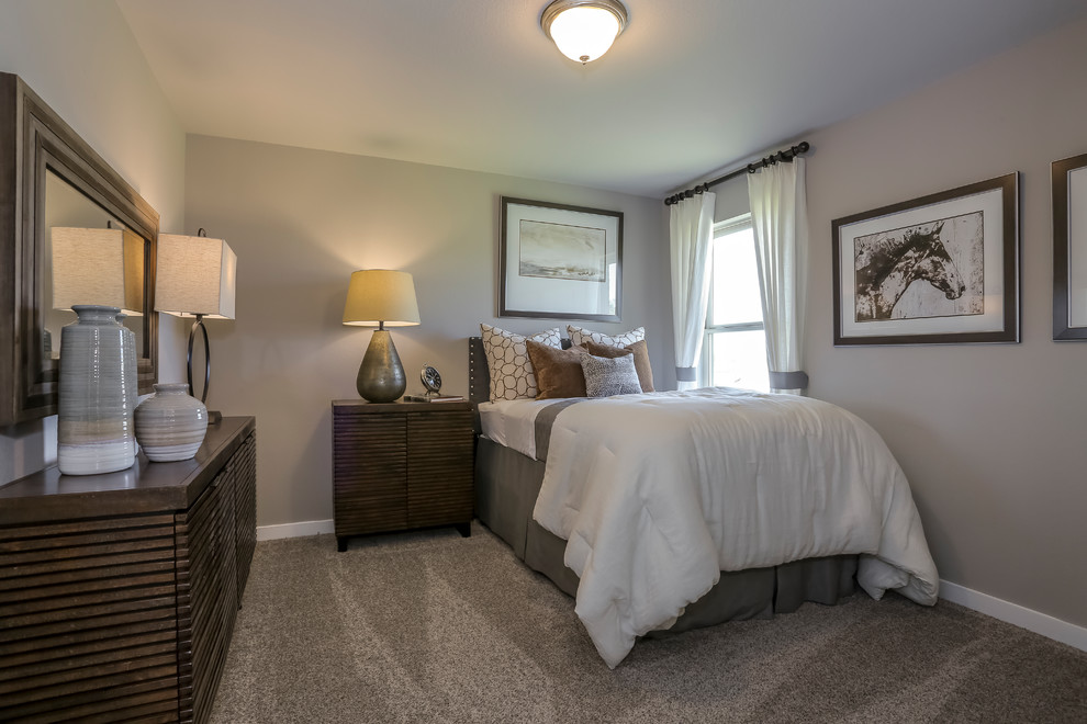 Large contemporary guest bedroom in Houston with beige walls, carpet and beige floor.
