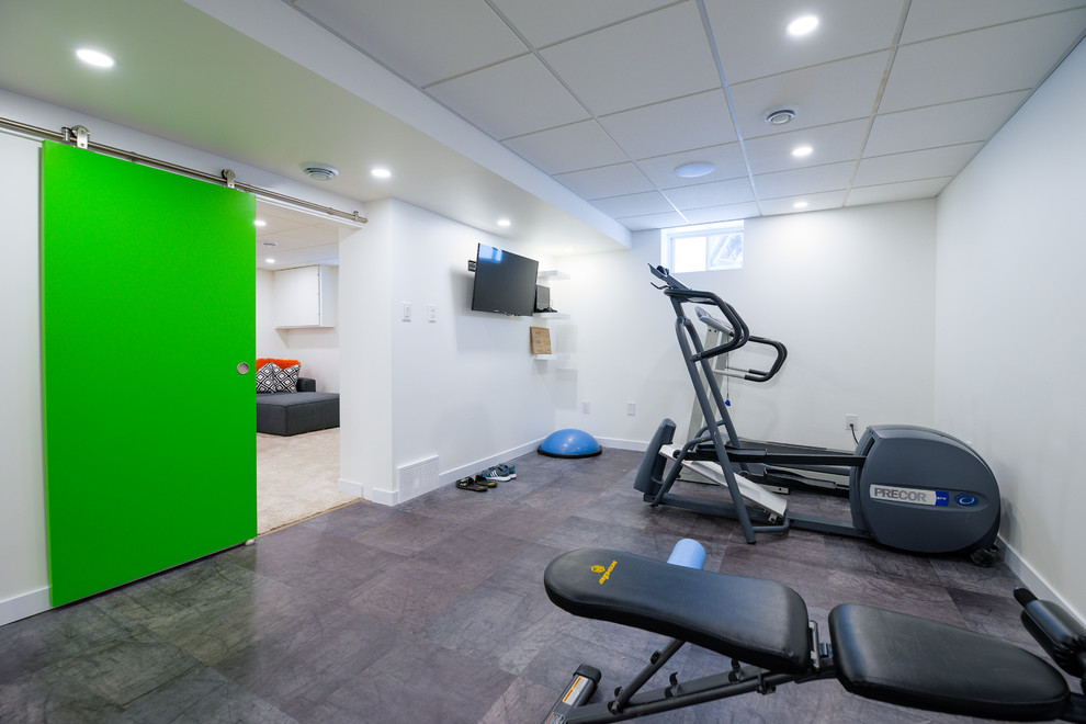 Photo of a small contemporary multipurpose gym in Other with white walls, vinyl floors and grey floor.