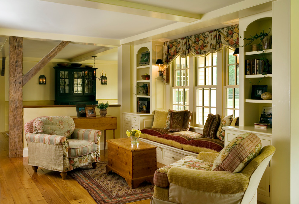 Photo of a large country open concept living room in Boston with yellow walls, medium hardwood floors and a library.