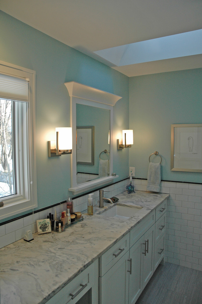 Inspiration for a mid-sized transitional master white tile and subway tile porcelain tile and gray floor alcove bathtub remodel with shaker cabinets, white cabinets, a two-piece toilet, blue walls, an undermount sink, marble countertops and white countertops