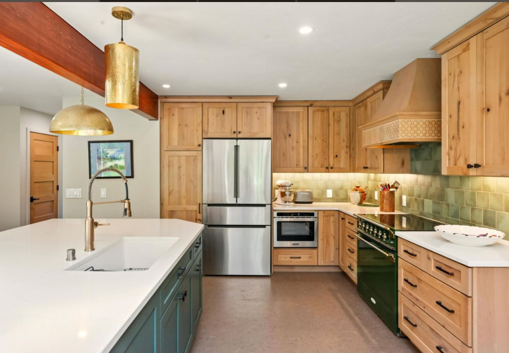 Example of a mid-sized transitional cork floor and brown floor kitchen design with an undermount sink, shaker cabinets, light wood cabinets, quartz countertops, green backsplash, ceramic backsplash, stainless steel appliances, an island and white countertops