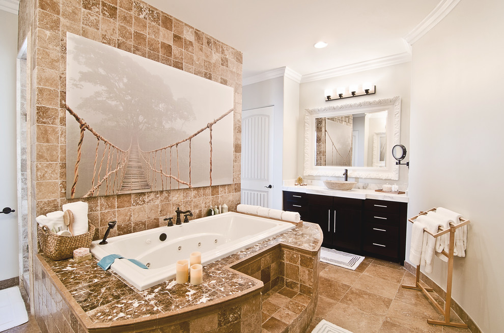 This is an example of a large transitional master bathroom in Phoenix with a vessel sink, marble benchtops, a drop-in tub, a double shower, beige tile, stone tile, travertine floors, grey walls, flat-panel cabinets and black cabinets.