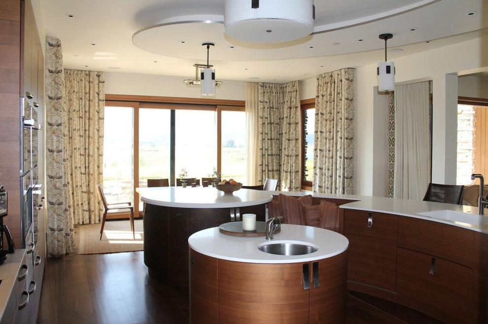 Large transitional kitchen photo in Denver with flat-panel cabinets, dark wood cabinets and an island